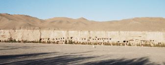 Rooms dug into the cliff face.